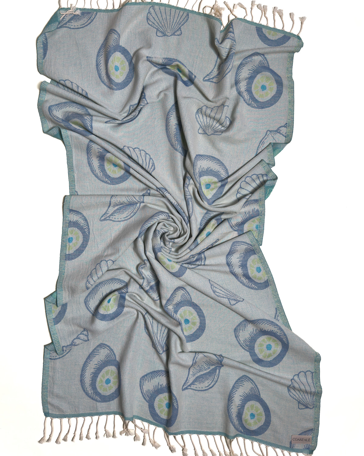 Front view of the twisted Charm organic Turkish cotton beach towel with California inspired jacquard design. Iconic Turkish Evil Eye, Turquoise.