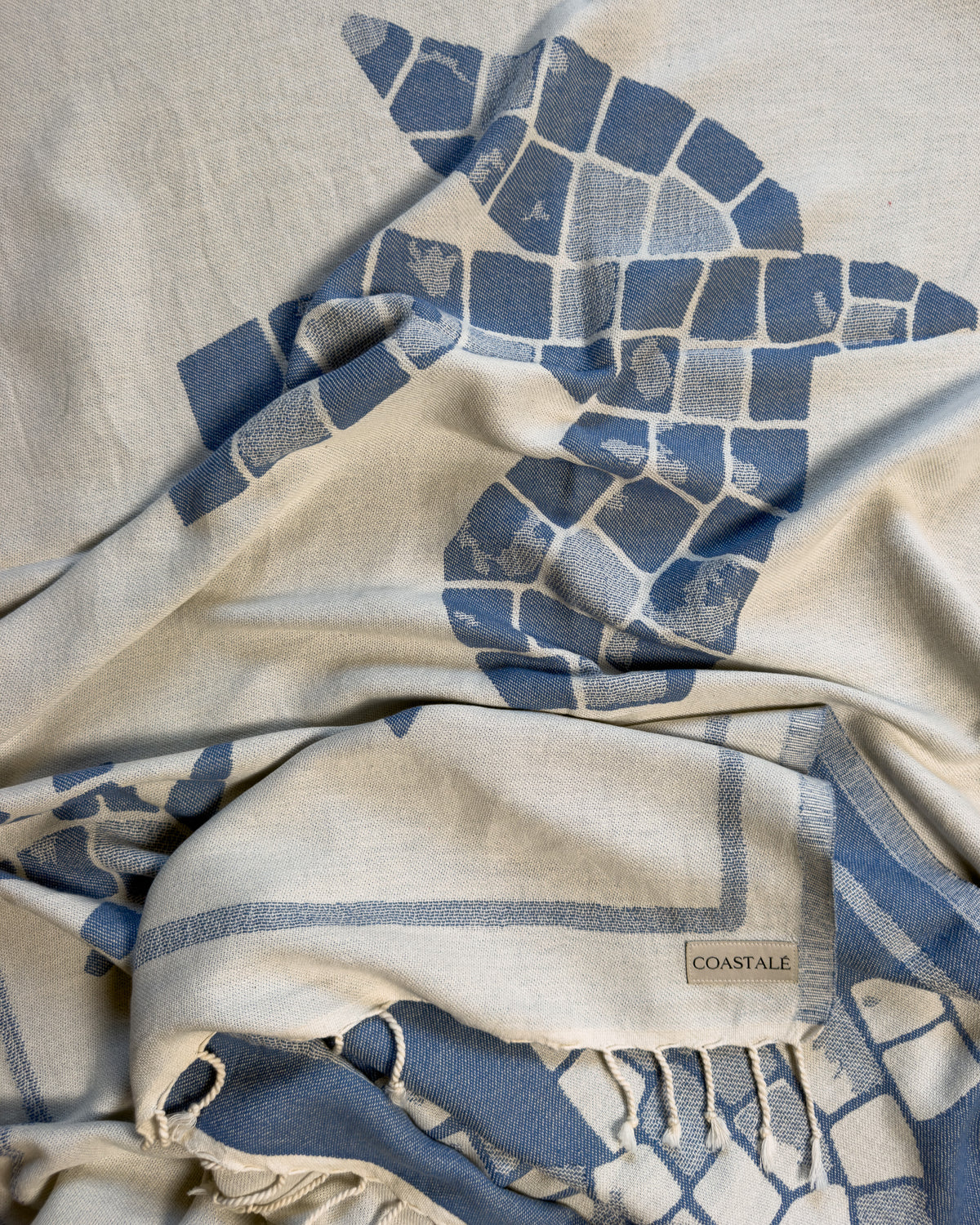 Front view of the twisted Glide organic Turkish cotton beach towel with California inspired jacquard design