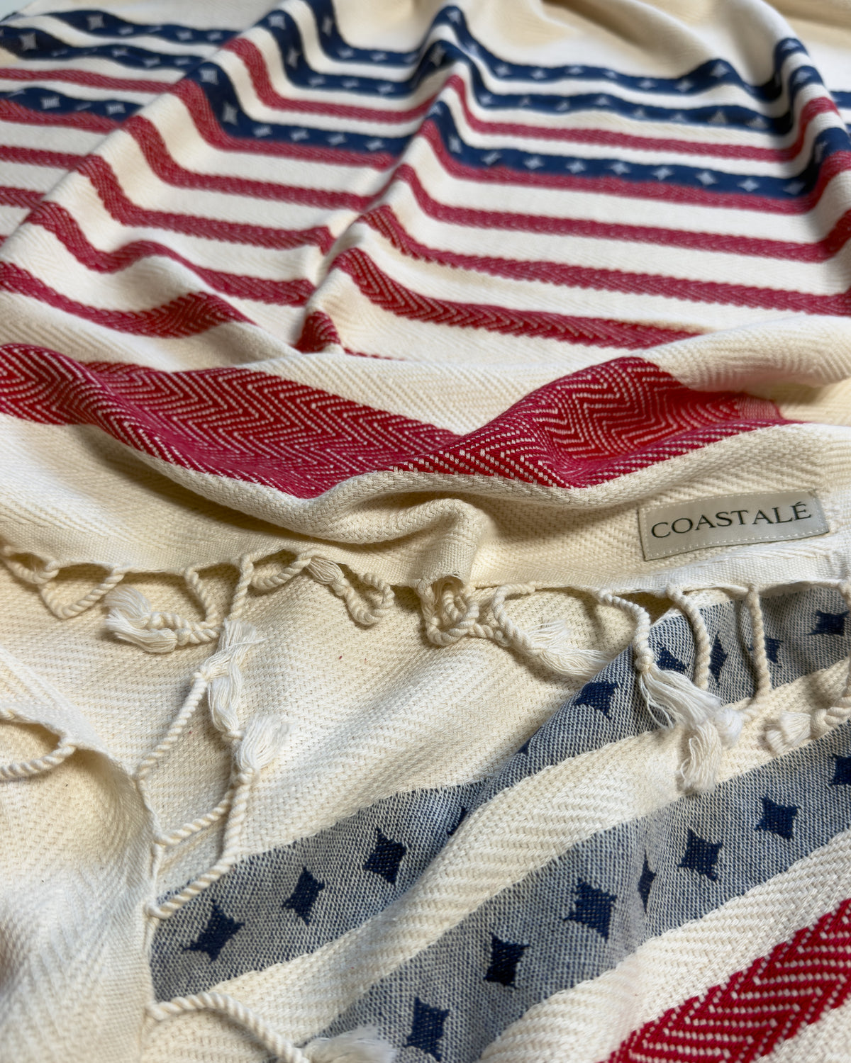 Front view of the twisted Old Glory organic Turkish cotton beach towel with California inspired jacquard design. 4th July, American Flag design.