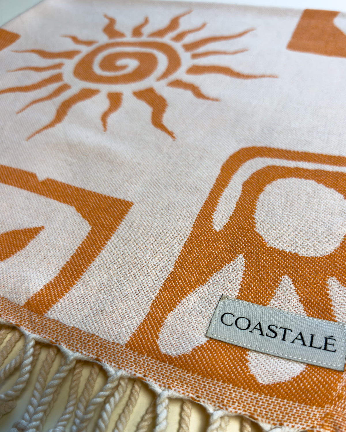 COASTALÉ label on the Postcards orange organic Turkish cotton beach towel