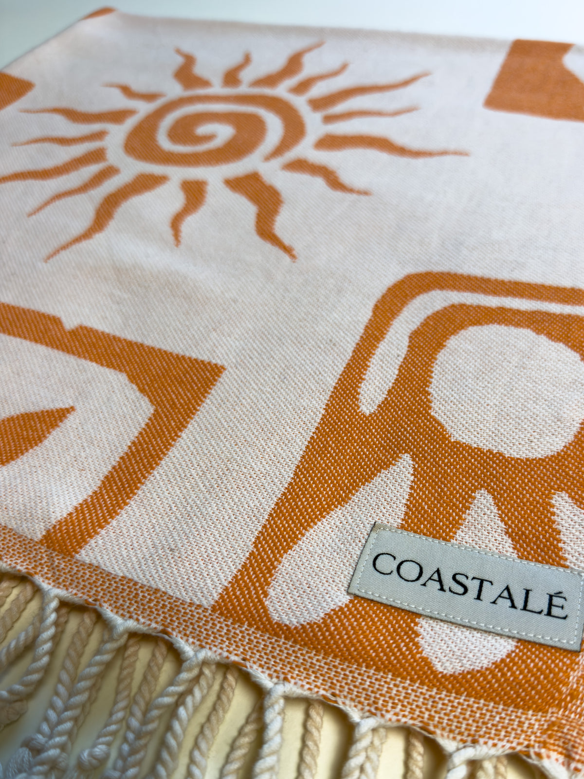 COASTALÉ label on the Postcards orange organic Turkish cotton beach towel