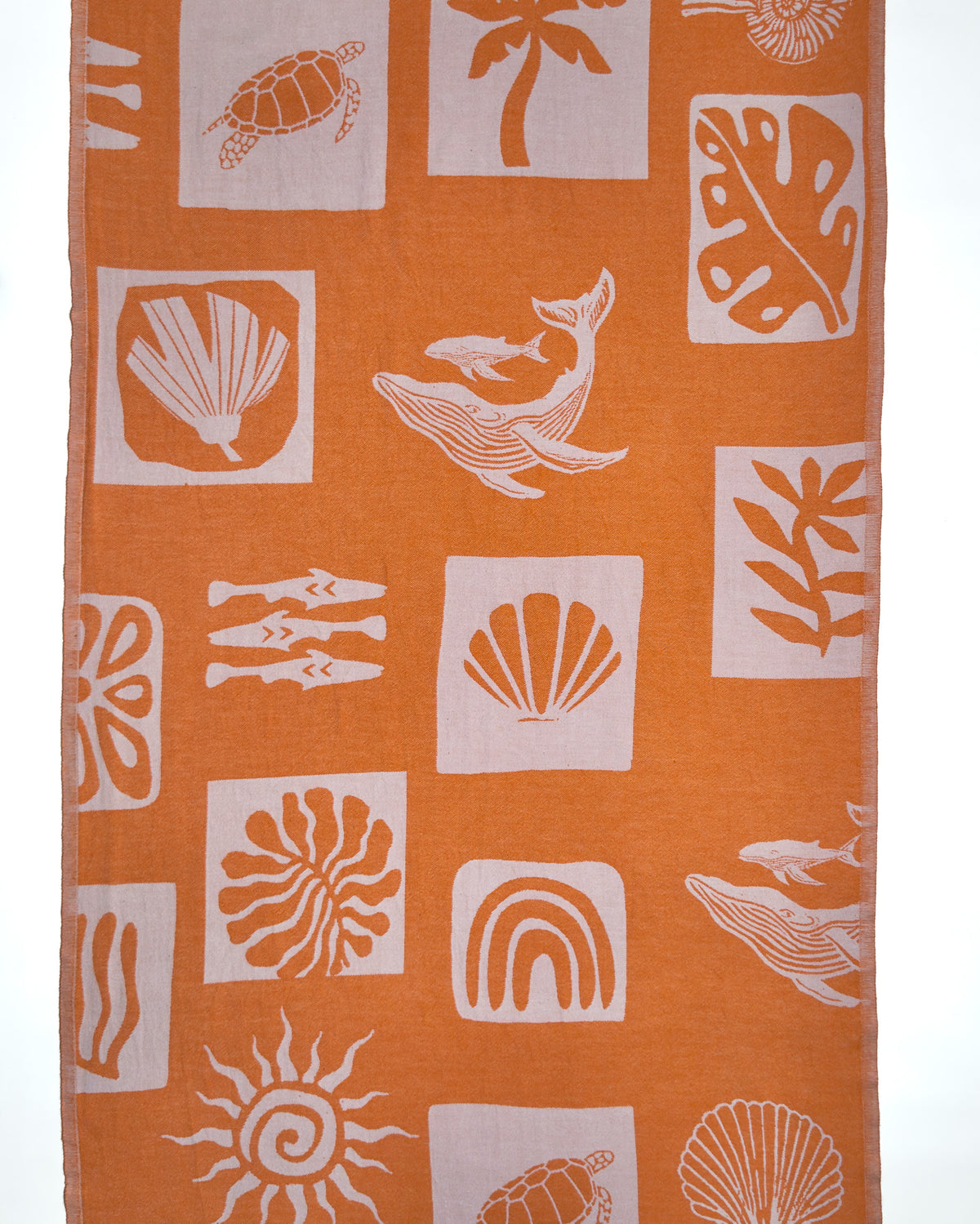 Back view of the Postcards reversible orange organic Turkish cotton beach towel