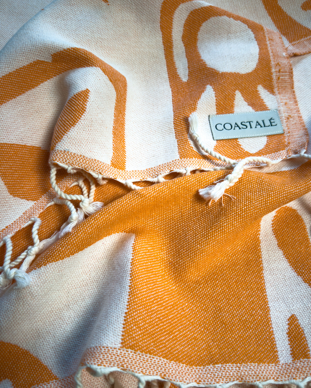 Close-up of the Postcards orange organic Turkish cotton beach towel