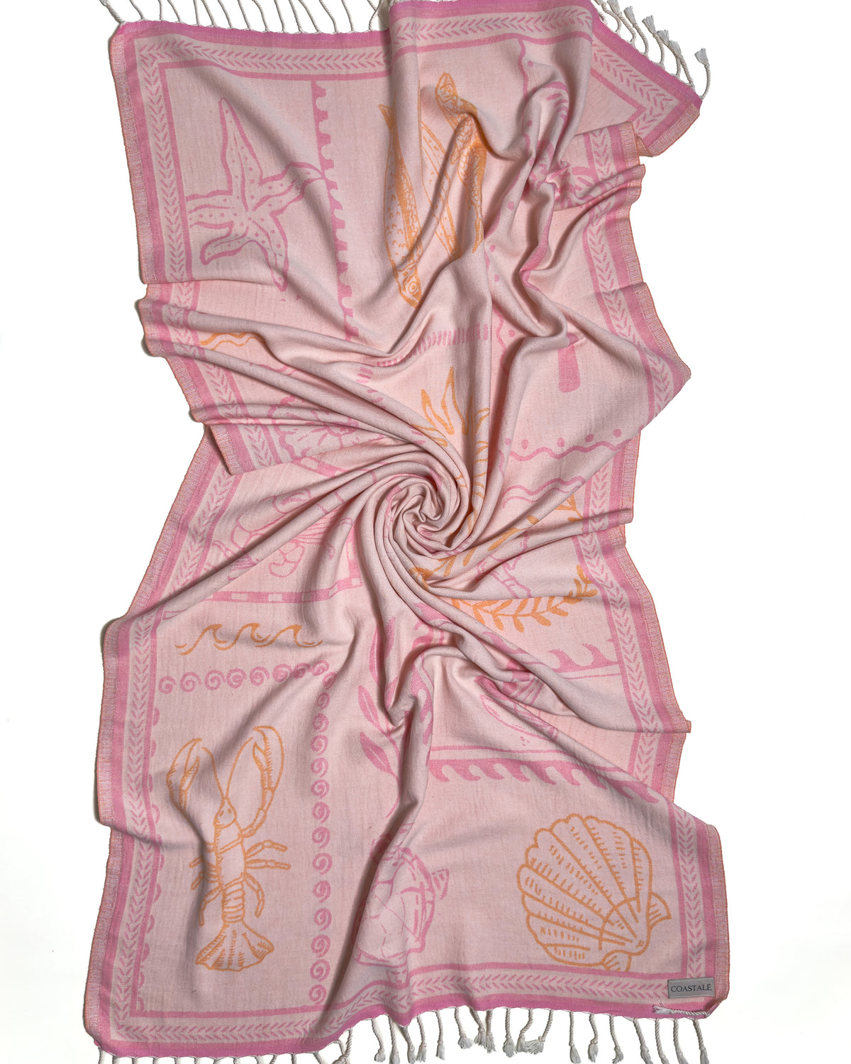 Front view of the twisted Shore Treasures pink organic Turkish cotton beach towel with California inspired jacquard design