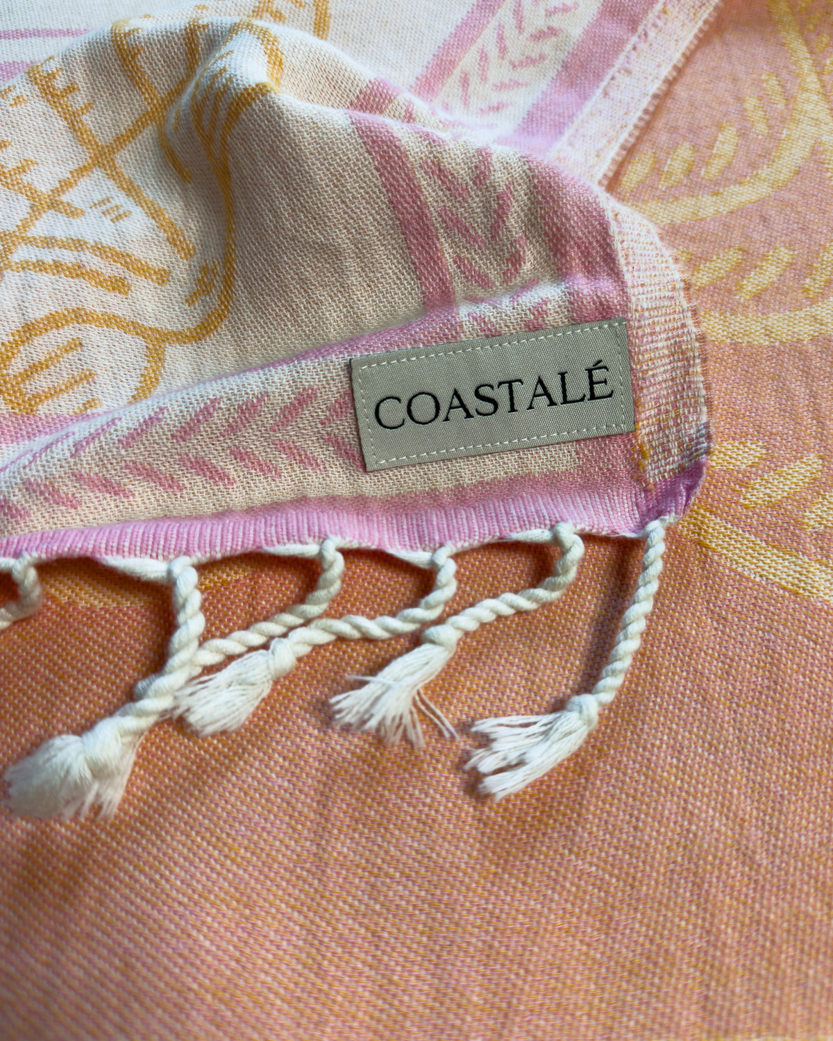 Close-up of the Shore Treasures pink organic Turkish cotton beach towel