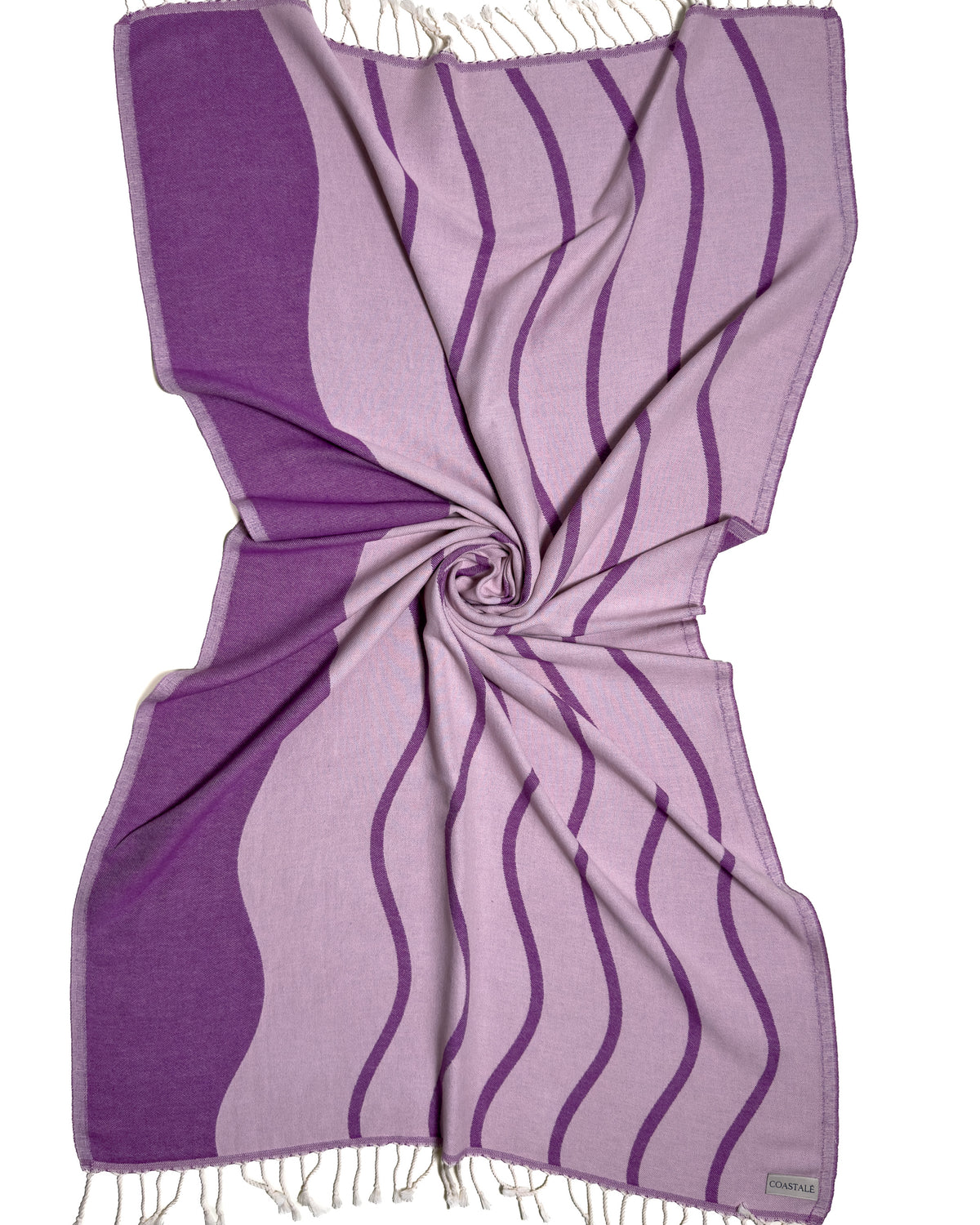 Front view of the twisted Swell purple organic Turkish cotton beach towel with California inspired jacquard design