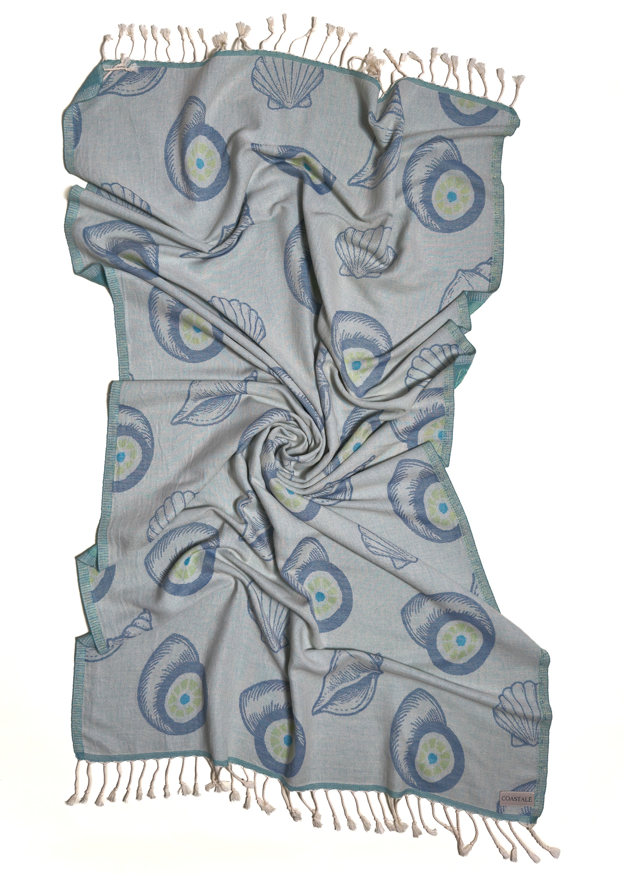 Front view of the twisted Charm organic Turkish cotton beach towel with California inspired jacquard design. Iconic Turkish Evil Eye, Turquoise.