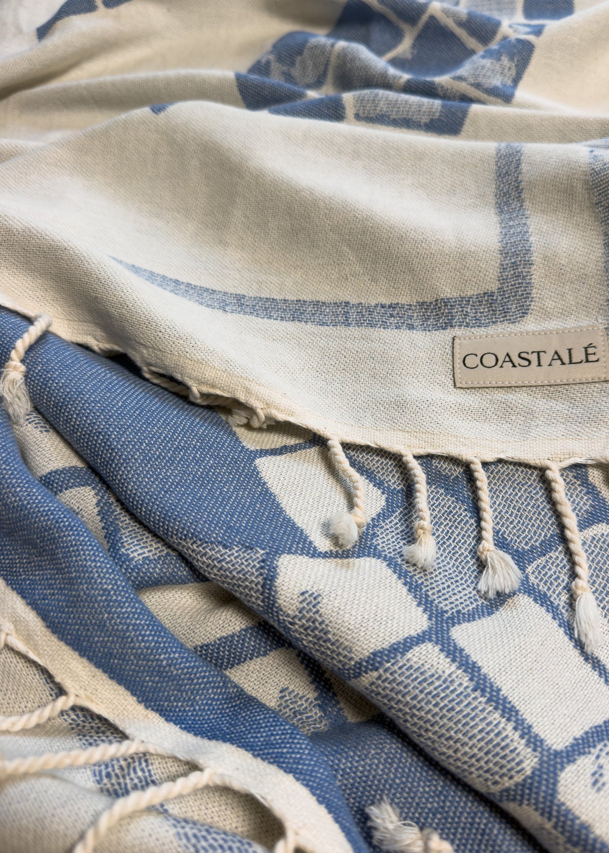 COASTALÉ label on the Glide organic Turkish cotton beach towel
