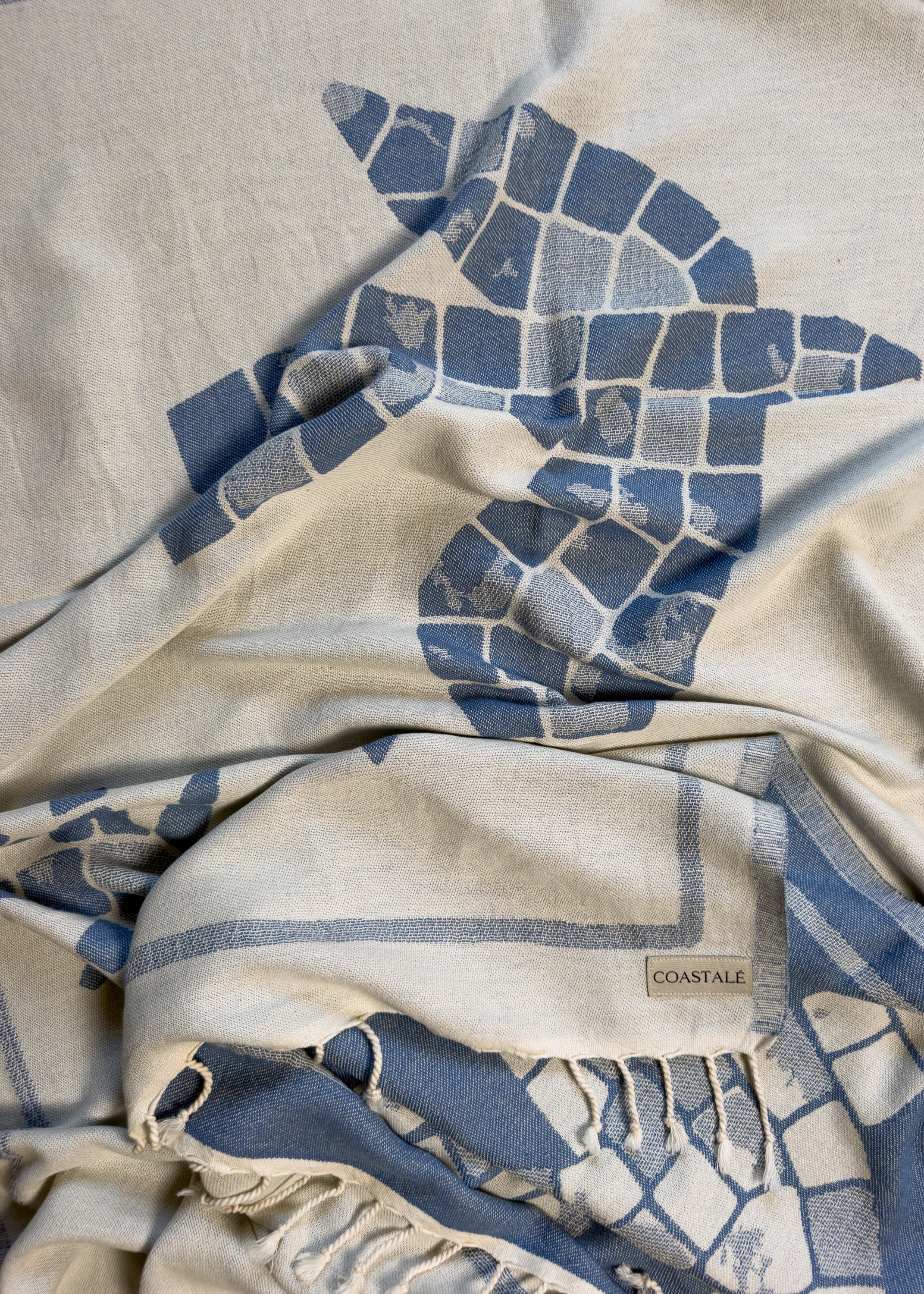 Front view of the twisted Glide organic Turkish cotton beach towel with California inspired jacquard design