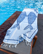Front view of the Mosaic organic Turkish cotton beach towel in pool view
