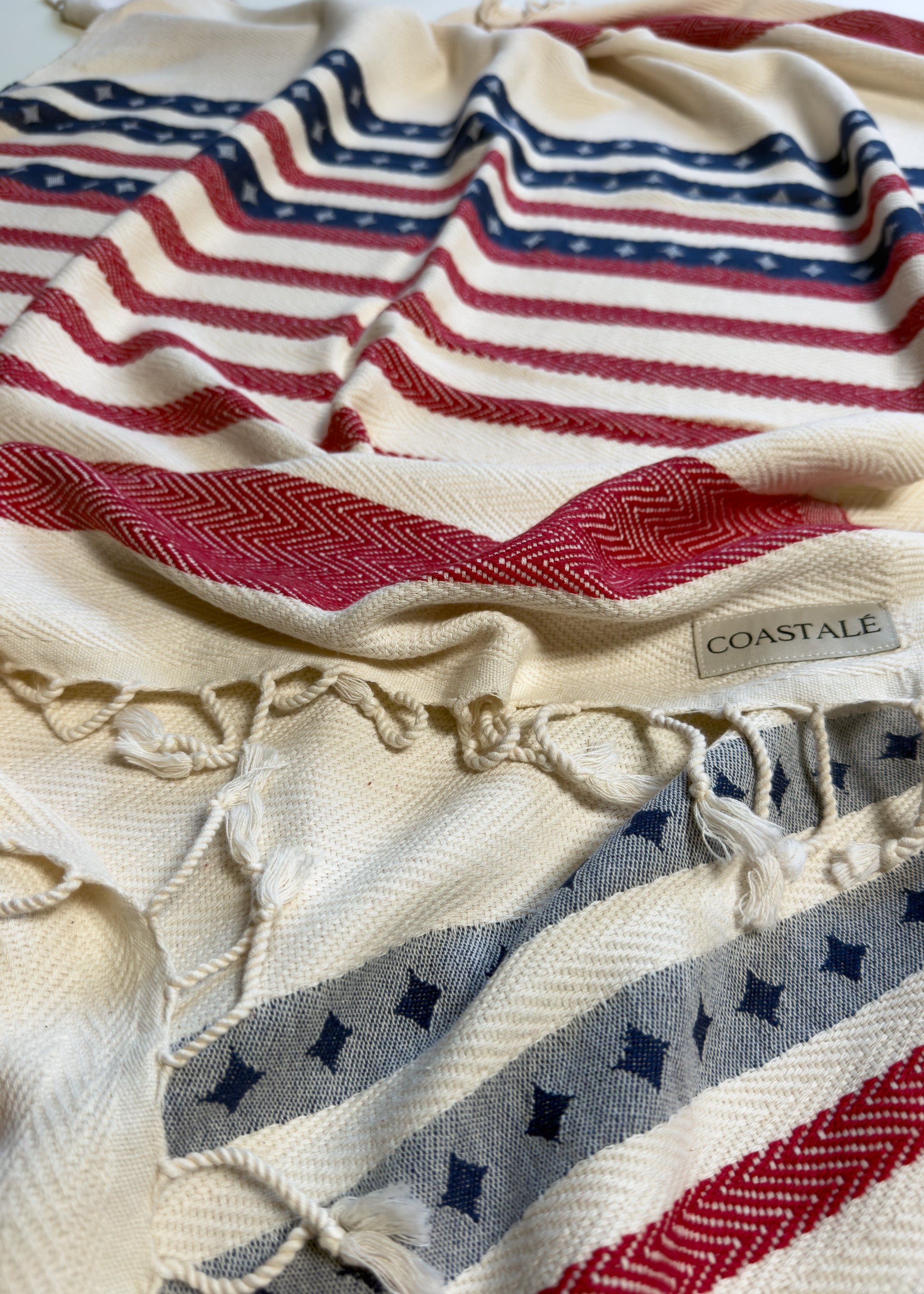 Front view of the twisted Old Glory organic Turkish cotton beach towel with California inspired jacquard design. 4th July, American Flag design.