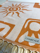COASTALÉ label on the Postcards orange organic Turkish cotton beach towel