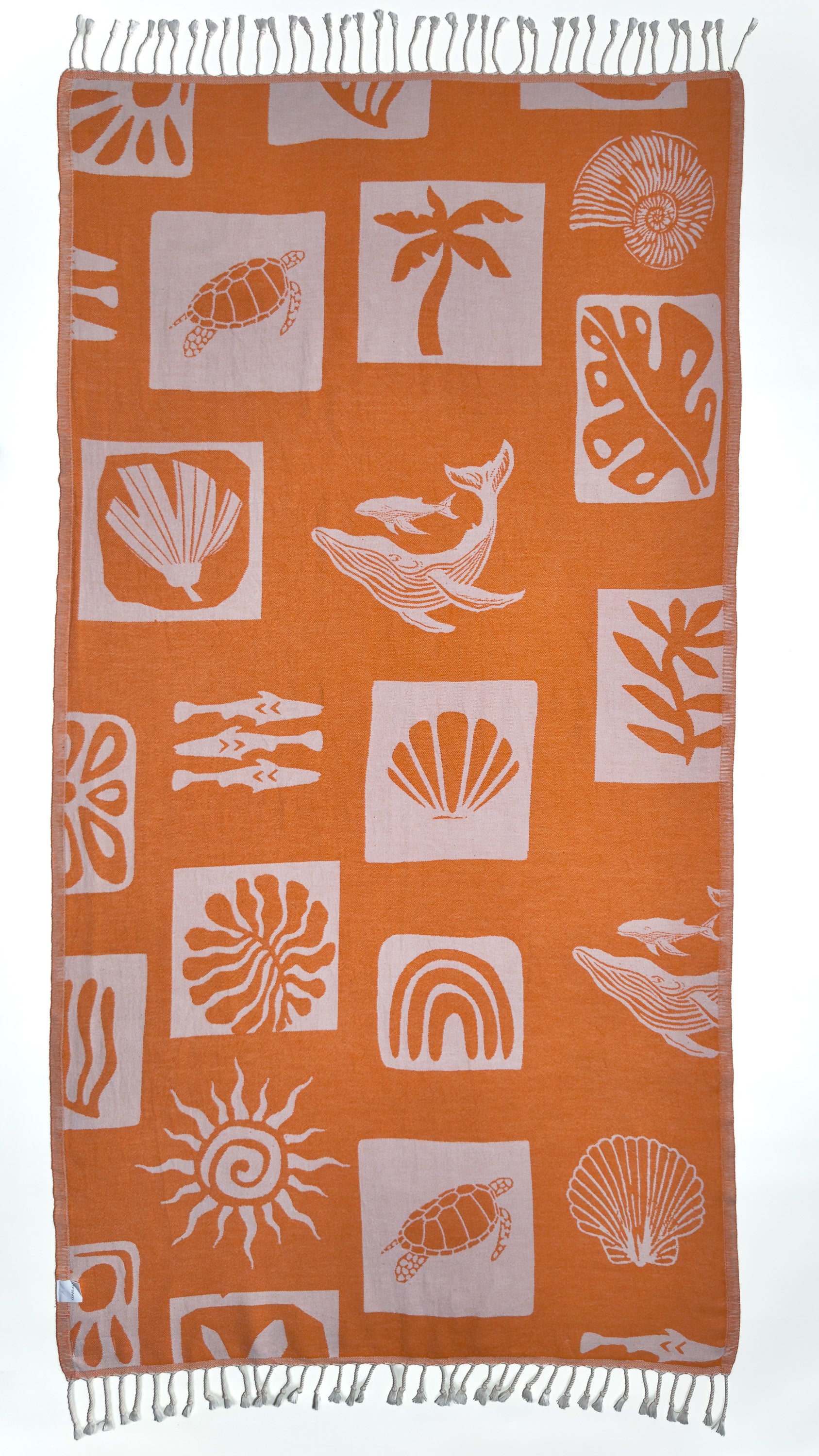 Back view of the Postcards reversible orange organic Turkish cotton beach towel