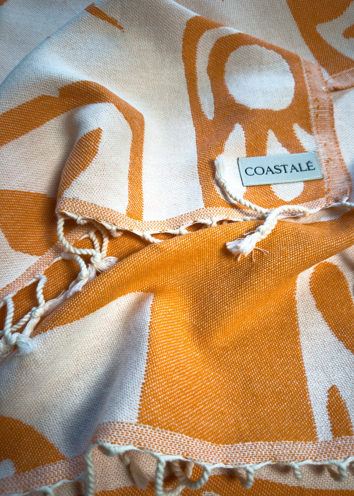 Close-up of the Postcards orange organic Turkish cotton beach towel