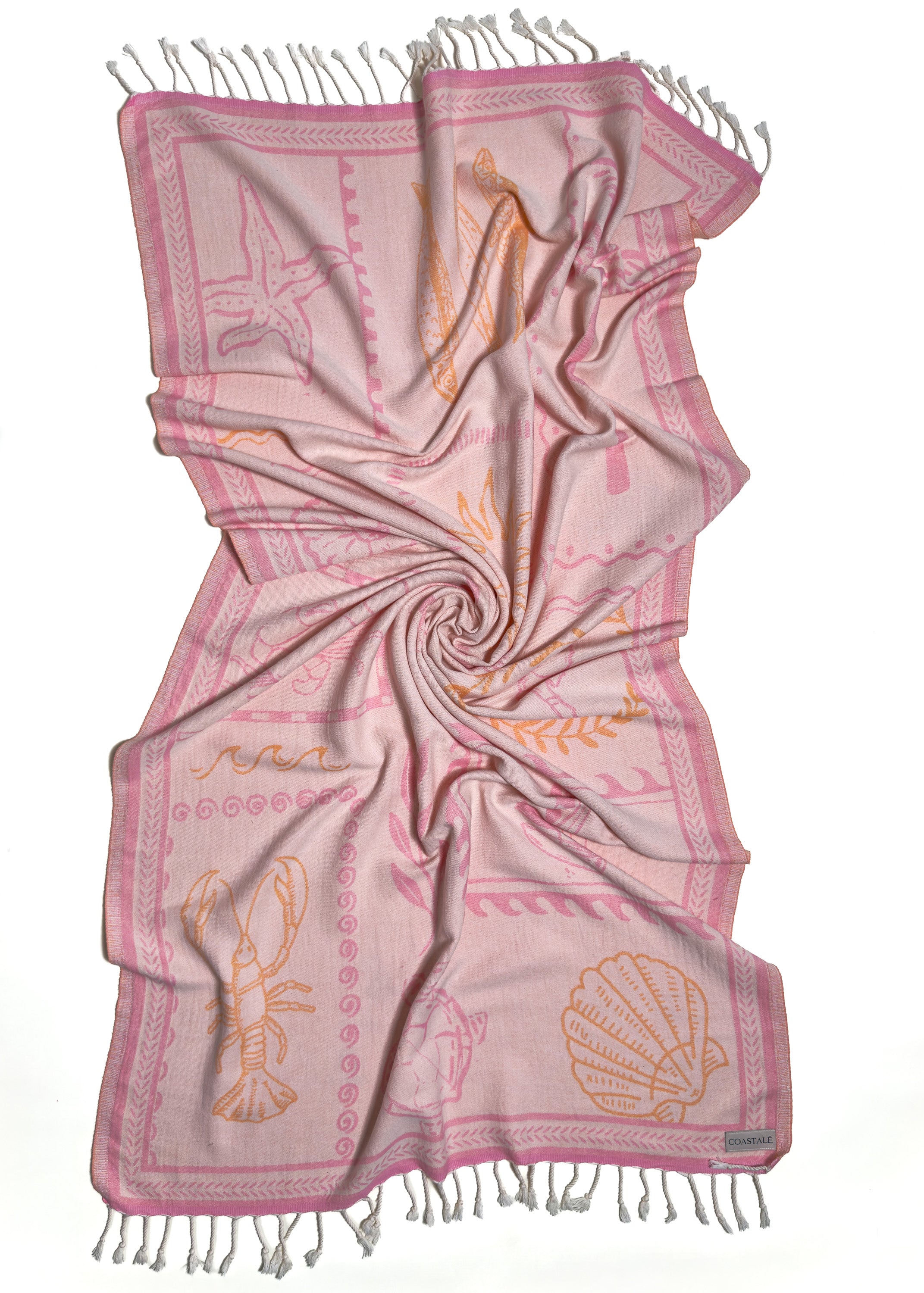 Front view of the twisted Shore Treasures pink organic Turkish cotton beach towel with California inspired jacquard design