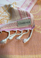 Close-up of the Shore Treasures pink organic Turkish cotton beach towel