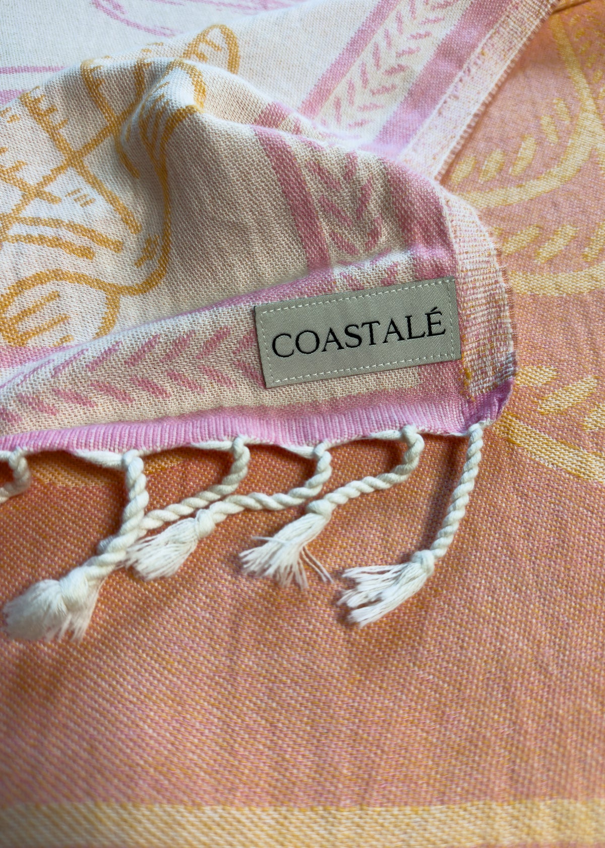 Close-up of the Shore Treasures pink organic Turkish cotton beach towel